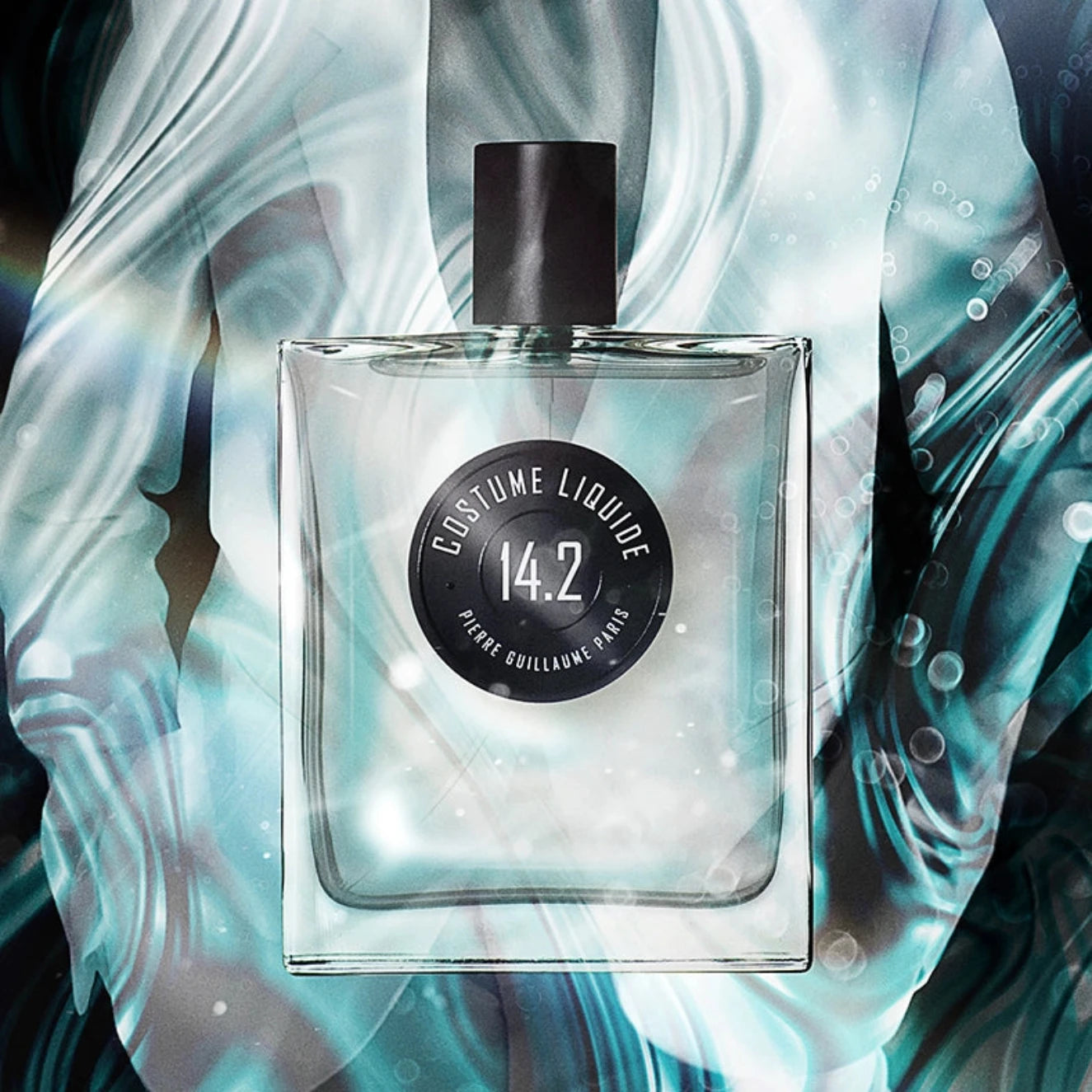 Perfume bottle with a black cap and label on a light blue and white abstract background