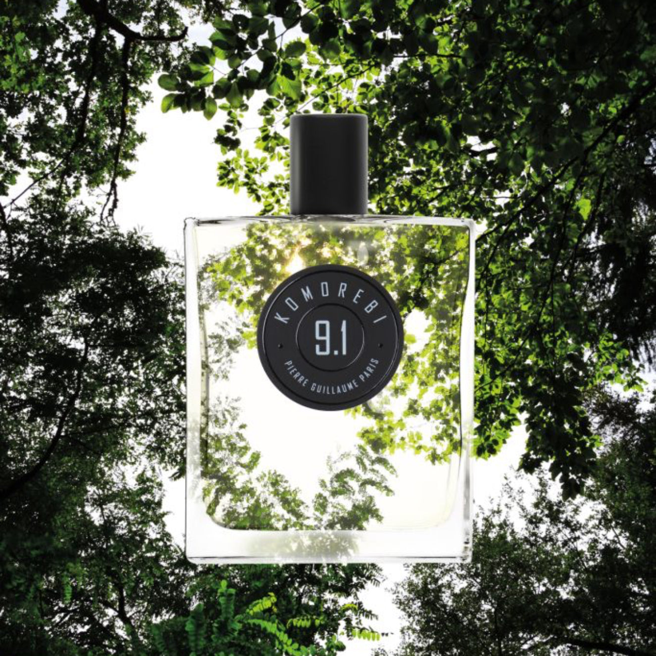 Perfume bottle labeled '9.1' with a natural background of trees