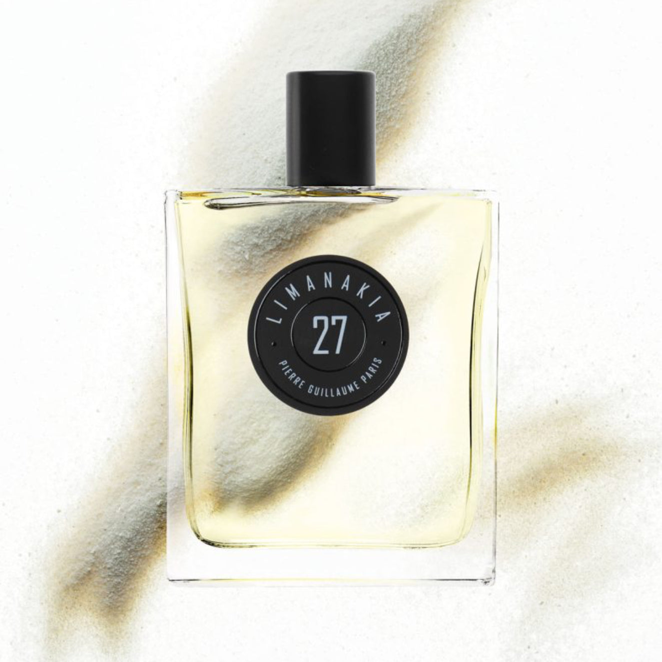 Perfume bottle with a black cap and label on a white background